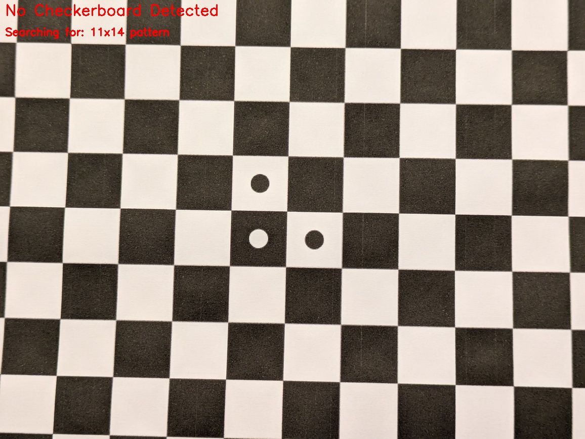 Calibration checkerboard with circular markers and a red overlay reading “No Checkerboard Detected” and “Searching for: 11×14 pattern”.